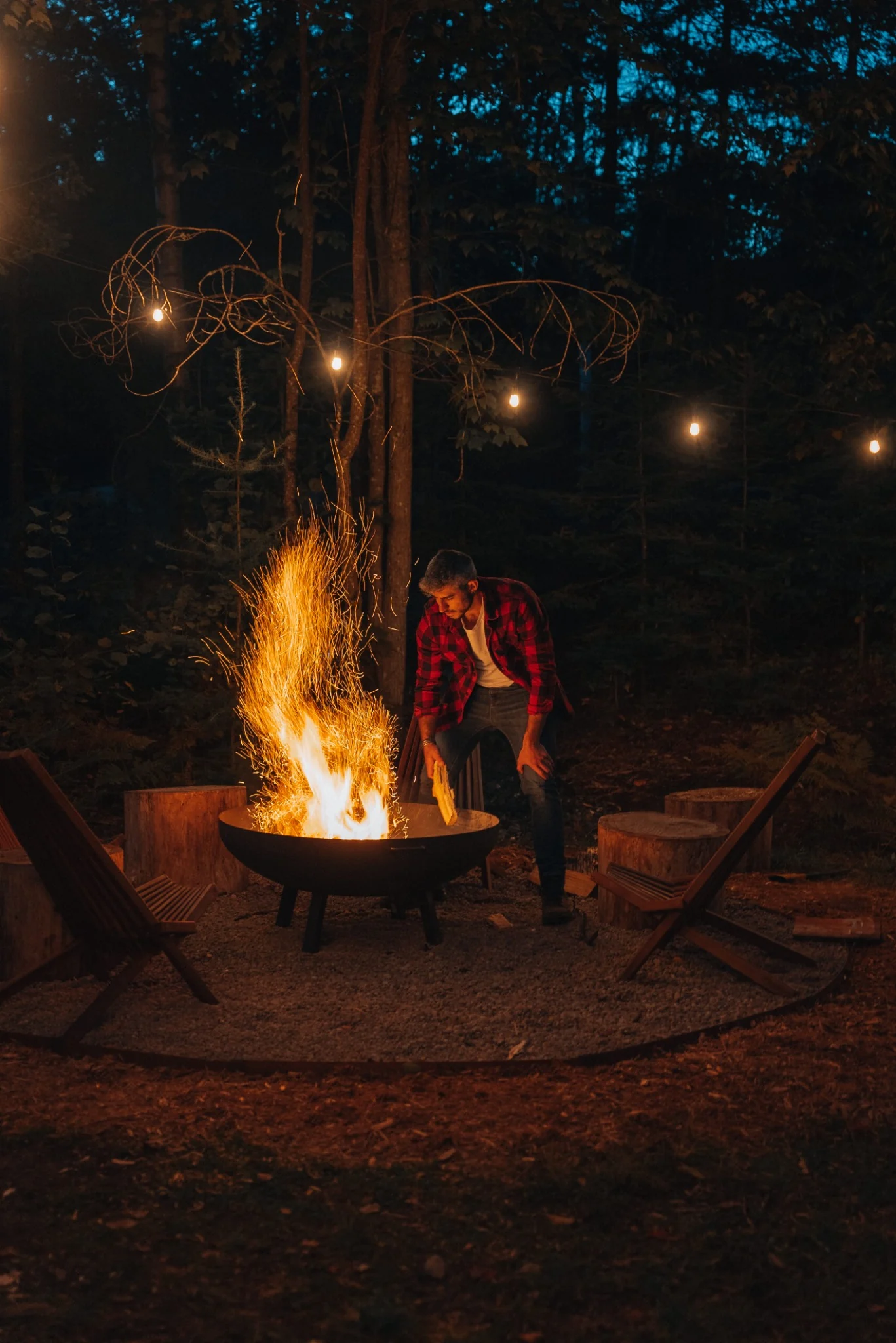 Secluded fire pit glowing beneath the trees at WOLM Cabin