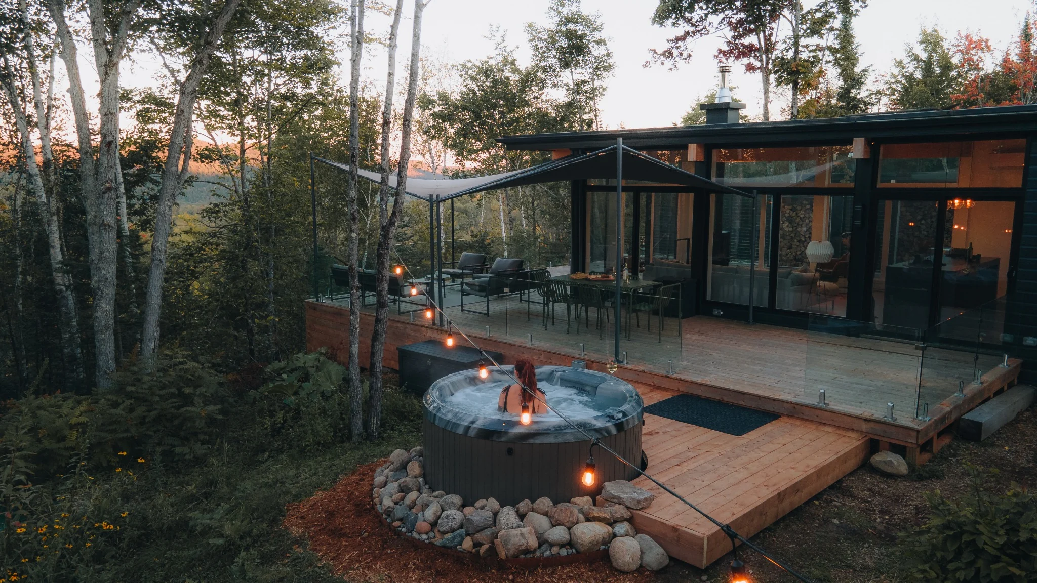 Private hot tub with the full WOLM Cabin deck and forest setting